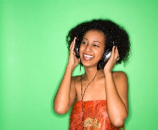 Photograph of a girl listening to music on headphones. Copyright Microsoft ClipArt.